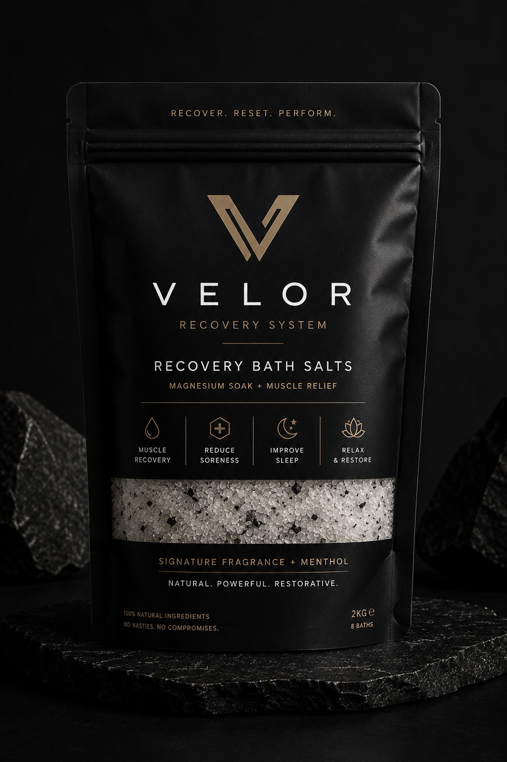 Velor Recovery Bath Salts pouch on dark stone with charcoal rocks